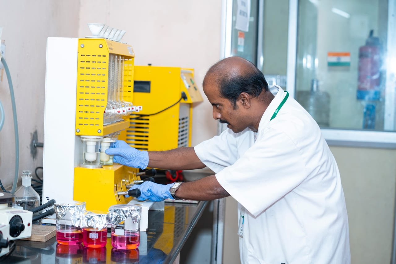 A laboratory technician operating an extraction and digestion unit