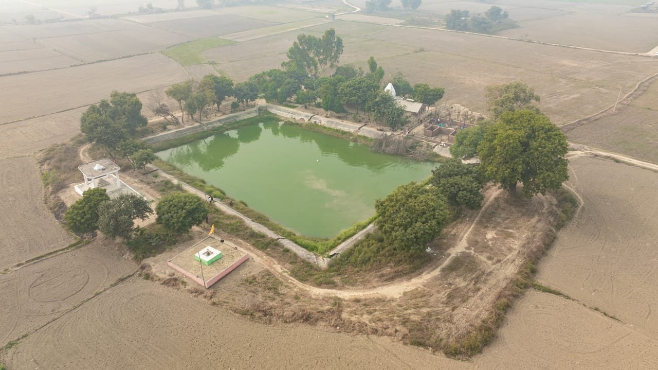 Aerial view of a rectangular village tank with trees along its bunds